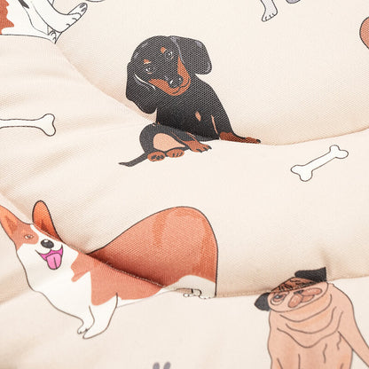 Close-up view of the Dog Daze pet mat fabric featuring playful illustrated dog characters and bone patterns on a soft, quilted beige surface.